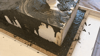 The melamine mould partly filled with the GFRC concrete mix